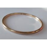 A 9ct yellow gold bangle, hallmarked, 65mm diameter, 16.73g