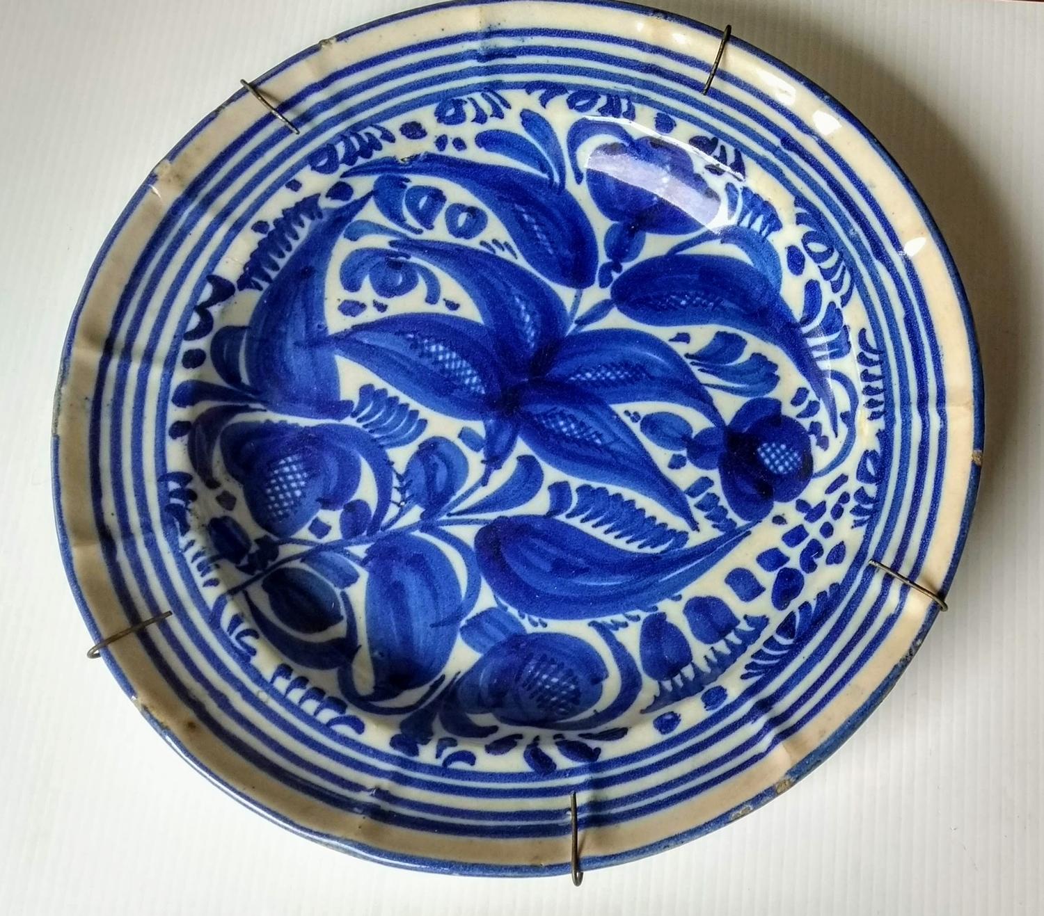 Two 18th century blue and white delft tin plate circular chargers with floral and foliate