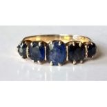 A sapphire five-stone ring with cushion-shape mixed-cut graduating sapphires approx 6.3mm-4mm x 5.