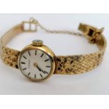 A 1970s ladies Tissot wristwatch with baton markers, 9ct gold case and mesh strap, hallmarked, in