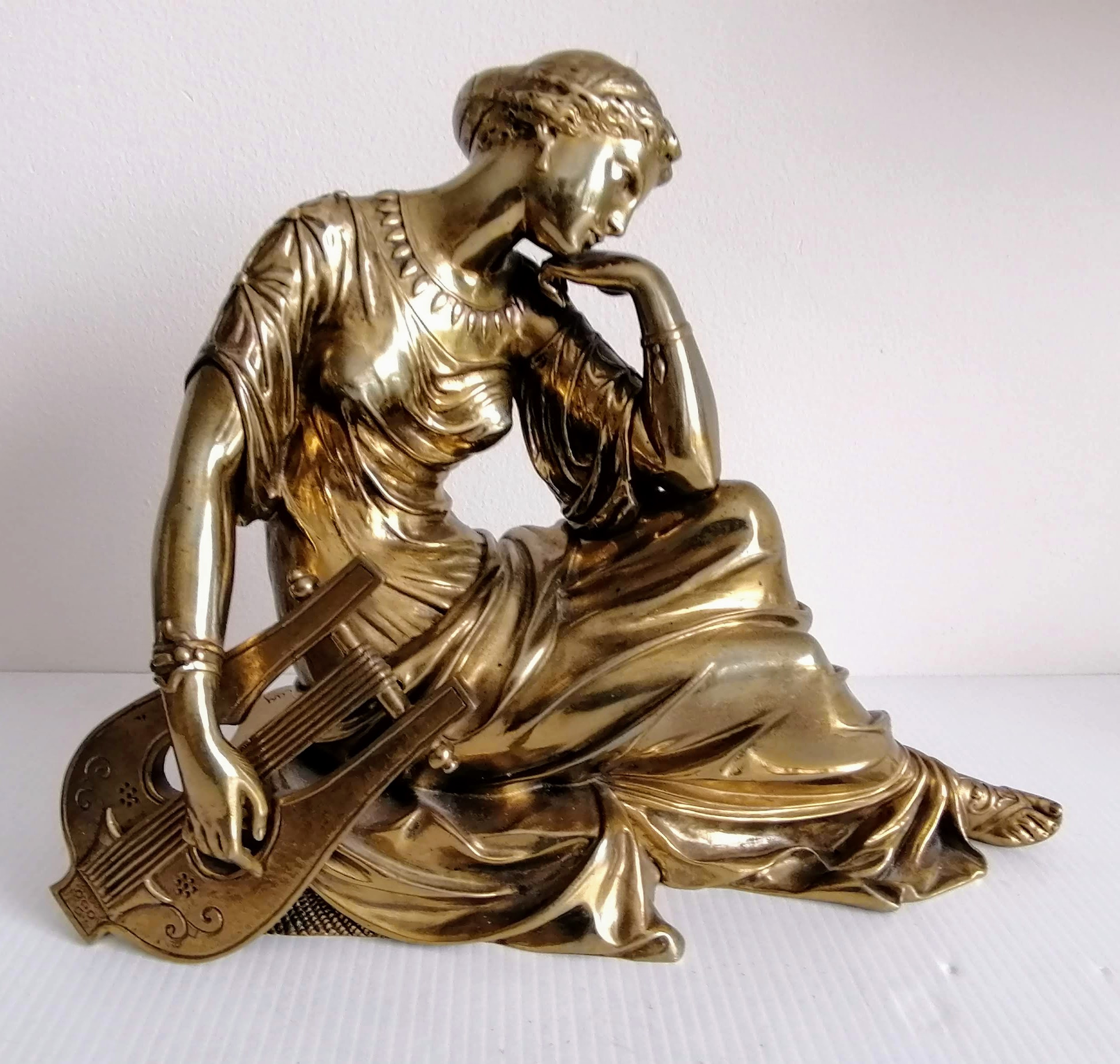 A bronze patinated figure of seated Sappho with lyre, signed Rlay to base, 24 cm W x 30 cm H