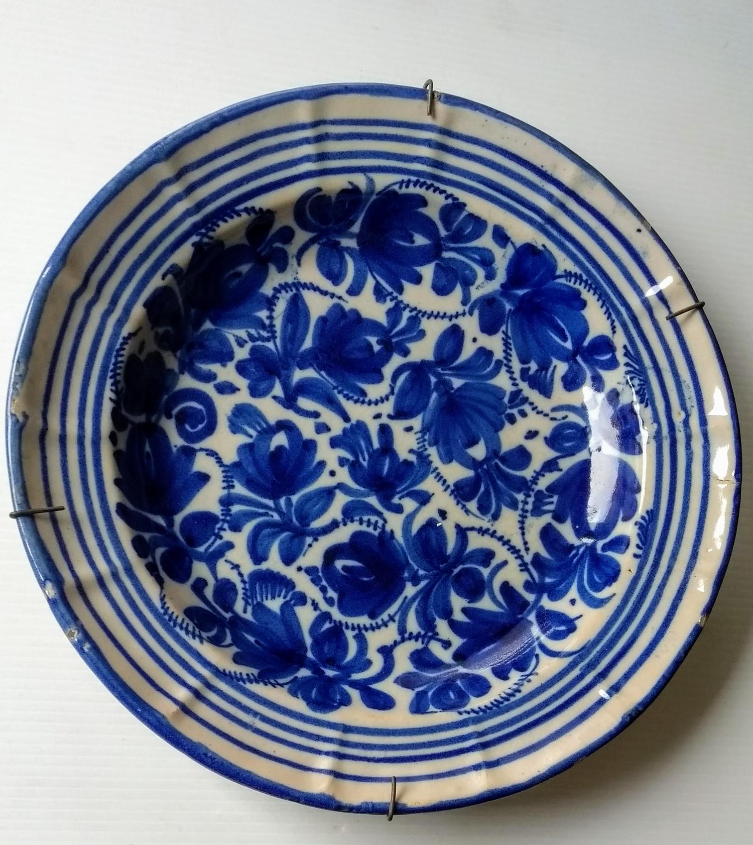 Two 18th century blue and white delft tin plate circular chargers with floral and foliate - Image 2 of 4