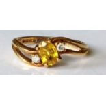 An 18ct gold lemon sapphire and diamond three-stone dress ring, the oval mixed-cut sapphire 5mm x
