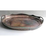A two-handled silver plated oval butler's tray with pierced decoration to gallery, 62 cm W and three