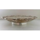 An Edward VIII silver table centre with wavy rim and pierced decoration on a raised circular base by