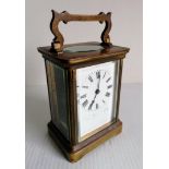 A recently serviced 19th century brass and bevelled glass cased carriage clock by Duverdry and