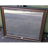 An oblong wood-framed bevelled wall mirror, 75 x 90 cm