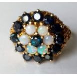 An opal and sapphire cluster dress ring on a 9ct gold setting, size T, hallmarked, 7.35g