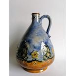 An Edwardian Doulton Lambeth whisky jug with mottled blue-ground and Celtic knot decoration,
