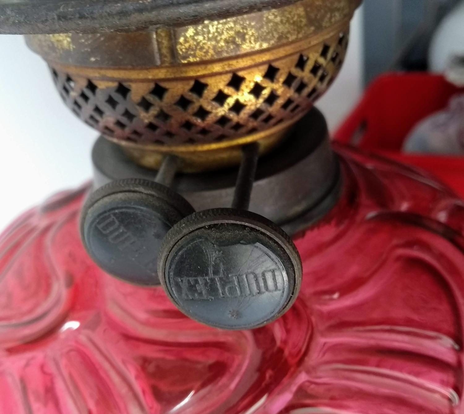 A Victorian ruby glass oil lamp with etched globular shade, chimney, wicks, on a pierced iron base - Image 2 of 2