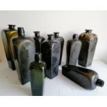 Nine 18th and 19th century Dutch green glass gin bottles, shortest 18.5 cm, tallest 28 cm, one