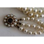 A vintage three-row graduated pearl choker necklace with ruby-set 9ct gold clasp, a similar Art Deco