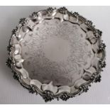 A Victorian silver salver with carved and etched decoration on three feet by William Stroud, London,