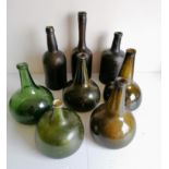 Three olive green onion-shape bottles, one other lighter green, another with slight iridescence