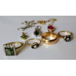 A gold wedding band and three other gem-set rings, a garnet pendant and chain, a white gold wishbone