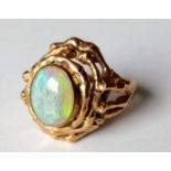 A contemporary gold ring with oval opal, size R, stamped 9ct, 6.81g