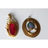 A mid-20th century 14ct yellow gold pendant with an elliptical garnet 9mm x 18mm and seed pearl