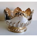 A Victorian silver monteith with extensive embossed rococo decoration on a raised base by