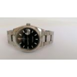 A Rolex Oyster Perpetual Date wristwatch with round black dial, 35mm, luminous markers, stainless