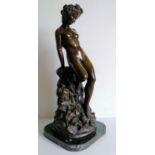 A bronzed figure of a young lady in repose on a square black marble base, 50 cm H