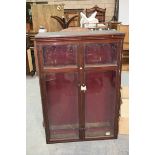 An early 20th Century glazed mahogany gun show case by Taylor Brothers, Sheffield Having a pair of