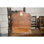 An early 20th Century oak hanging letter rack The scalloped back with a cross shaped aperture