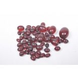 A selection of red beads Of vari-size, unstrung.