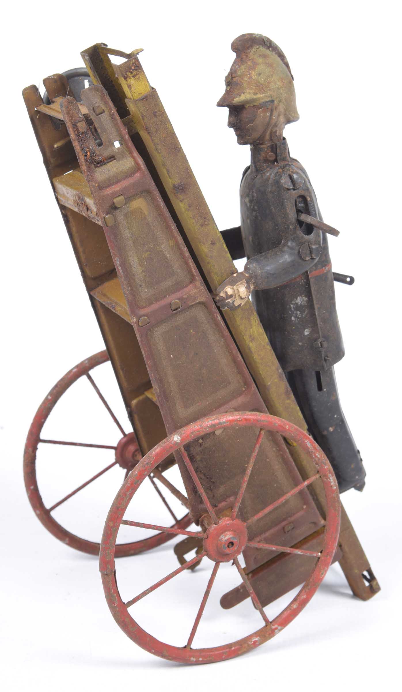 A Gama tinplate clockwork fireman With extending ladder, height 26cm