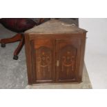 An Edwardian inlaid mahogany hanging corner cupboard The two inlaid doors enclosing two fixed