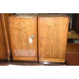 A pair of 1930's Art Deco walnut pedestal pot cupboards Each with a square top above a single