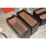 A pair of glazed stoneware planters The black glazed planters of rectangular form, 60x40x26cm.