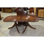 A Georgian style mahogany twin pedestal dining table, early 20th Century The rectangular top with