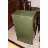 A vintage painted metal cabinet The single door enclosing a single metal shelf, complete with key