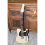 A Vintage V2 telecaster copy electric guitar Butterscotch with a black pick board, serial number