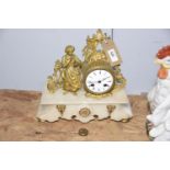 A late 19th Century French alabaster and gilt metal figural mantle clock The 9cm enameled dial