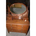 An Edwardian mahogany dressing table Having an oval bevelled mirror above two small drawers upon a
