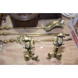 A group of brass fireside implements To include a pair of fire dogs with knight terminals, a coal