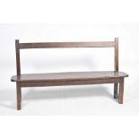 A late 19th/early 20th Century stained pine bench Having a rail back above a rectangular seat with