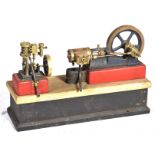 A pair of stationary steam engines Both with drive wheels attached to a wooden base