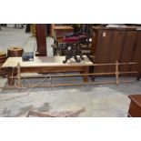 A vintage pine hanging clothes airer Having three rails and two turned cross stretchers, 285cm long.