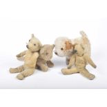 Four gold plush items Comprising a plush lion cub with glass eyes - seated, height 15cm, a brown and