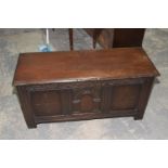 A 17th Century style oak coffer, 20th Century The rectangular moulded top above three panels and a