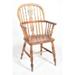 A 19th Century elm, ash and beechwood Windsor farmhouse elbow chair Having a pierced splat back