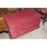 A Victorian red velour and mahogany otterman The rectangular padded hinged top above padded sides