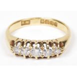 An 18ct gold diamond five stone ring The old cut diamond line with tapered shoulders, estimated
