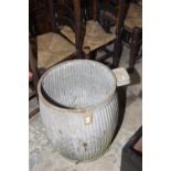 A vintage galvanised dolly tub Of typical reeded swelling form with an applied soap tray, 51cm high.