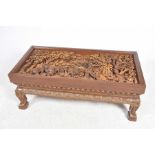 An impressive Thai carved hardwood coffee table The rectangular coffee table with a glass panel