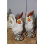 A glazed pottery cockerel figures (possibly Crown Staffordshire) The cockerels modeled on flowery