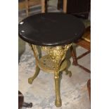 A painted Britannia cast iron pub table The circular hardwood top supported on three cast openwork