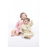 Two German bisque headed dolls Comprising a doll with brown wig, open/shut brown eyes, open mouth,